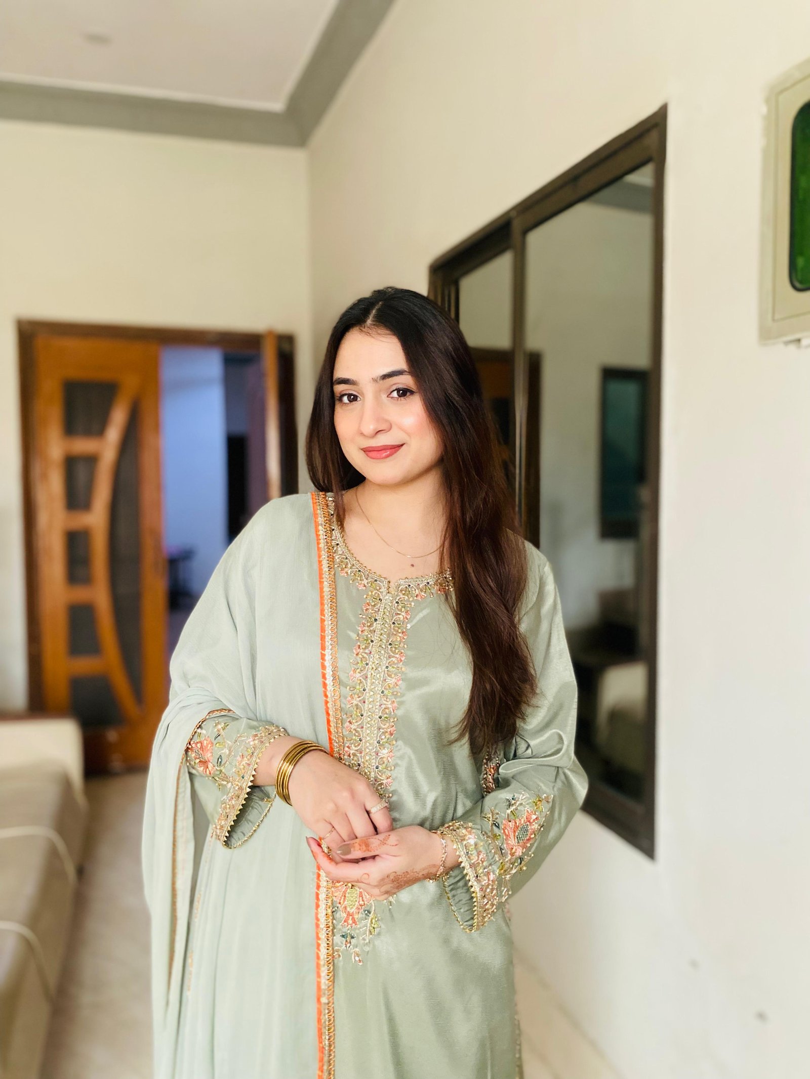 Ayesha in a pale green embroidered outfit
