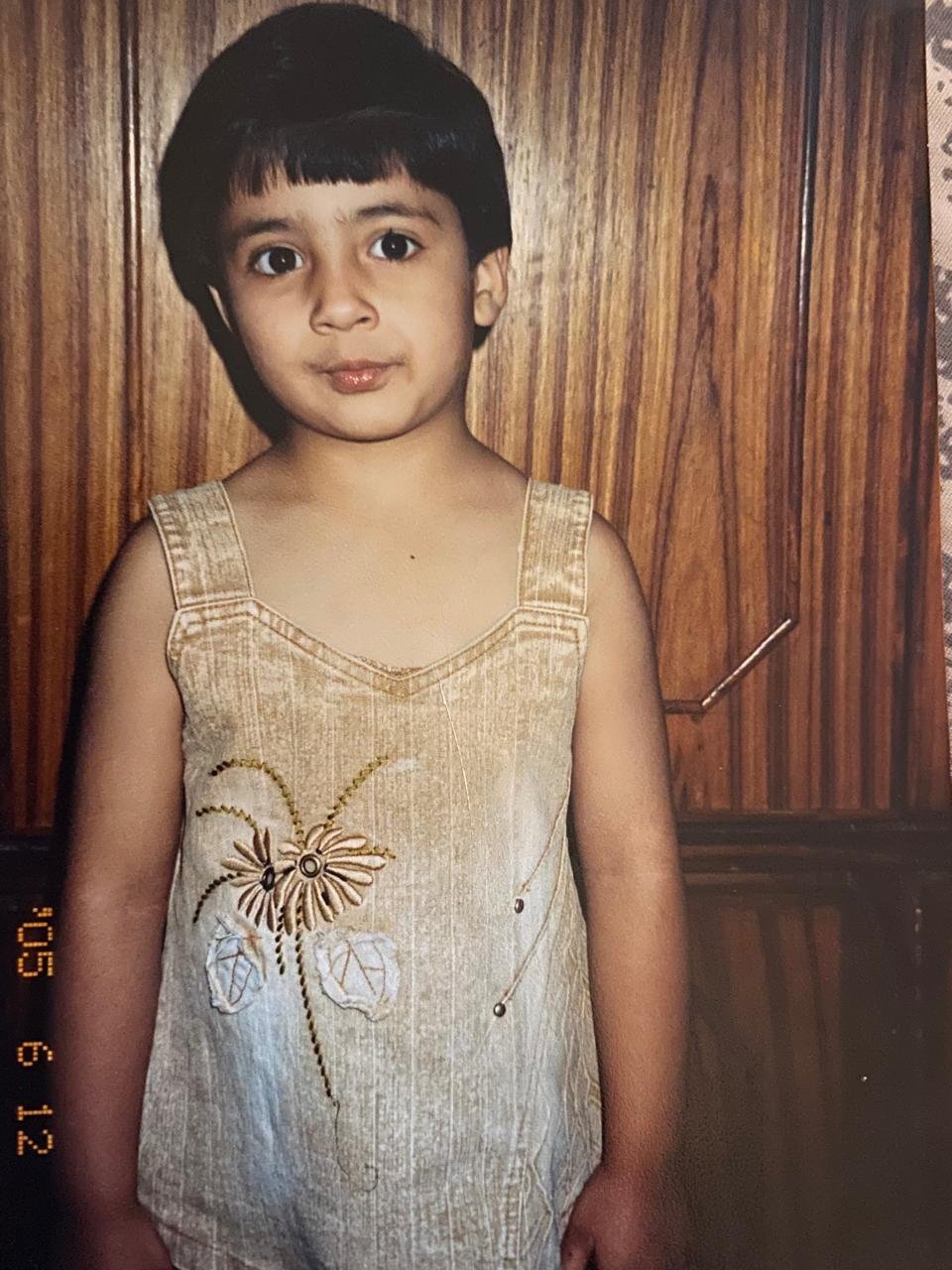 A childhood portrait in a light embroidered dress